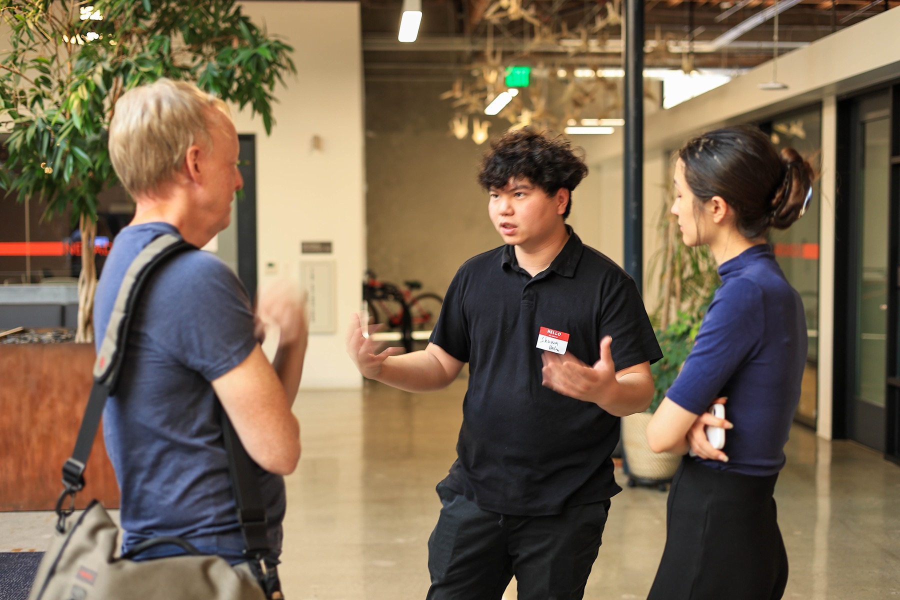 Three attendees in conversation during AI Infra Signal networking