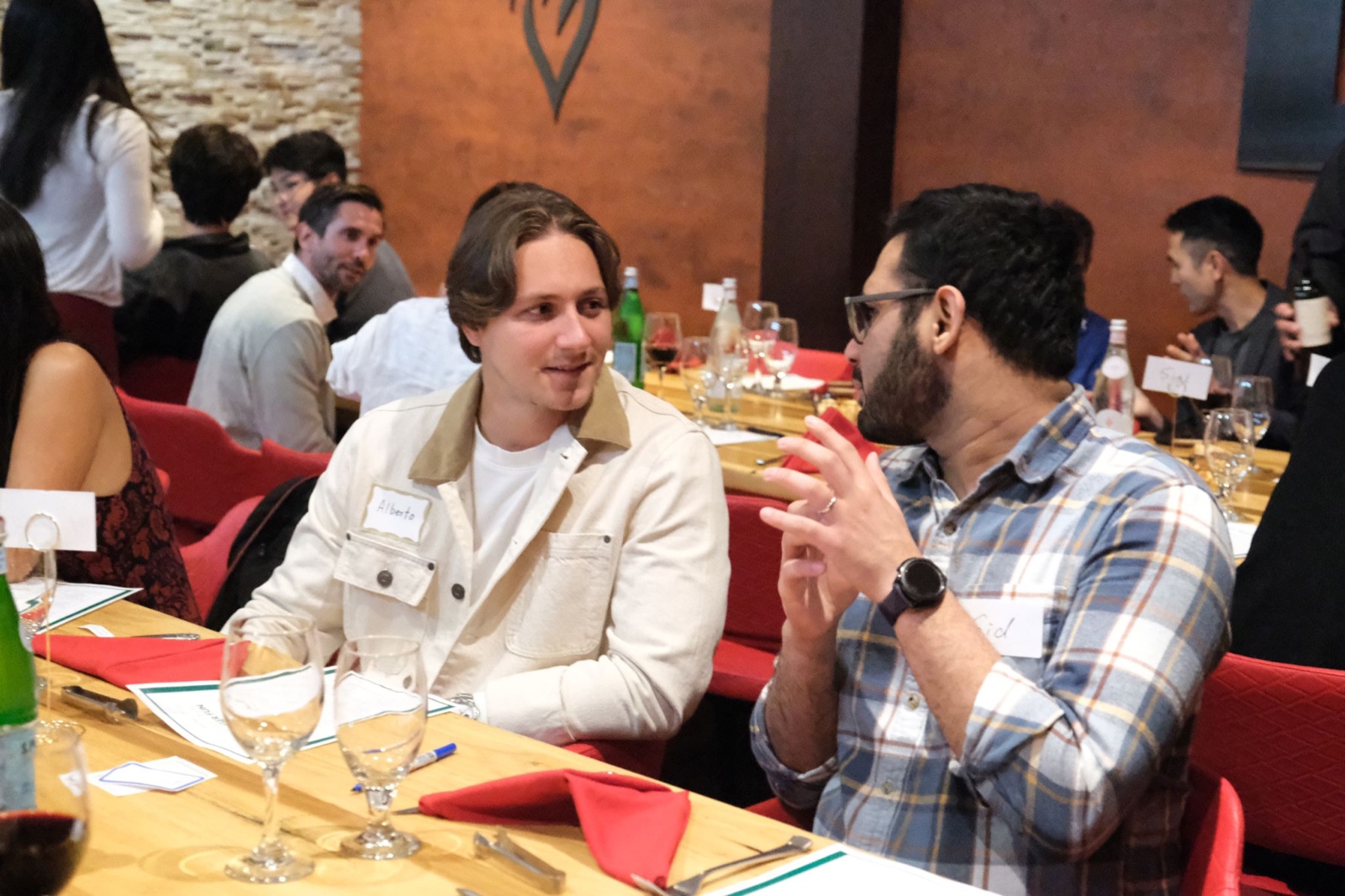 Two startup founders having a one-to-one conversation during the private Bay Area founders dinner